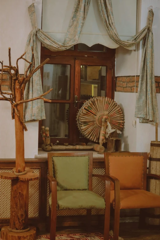 the interior of a house with chairs, tables and large fan