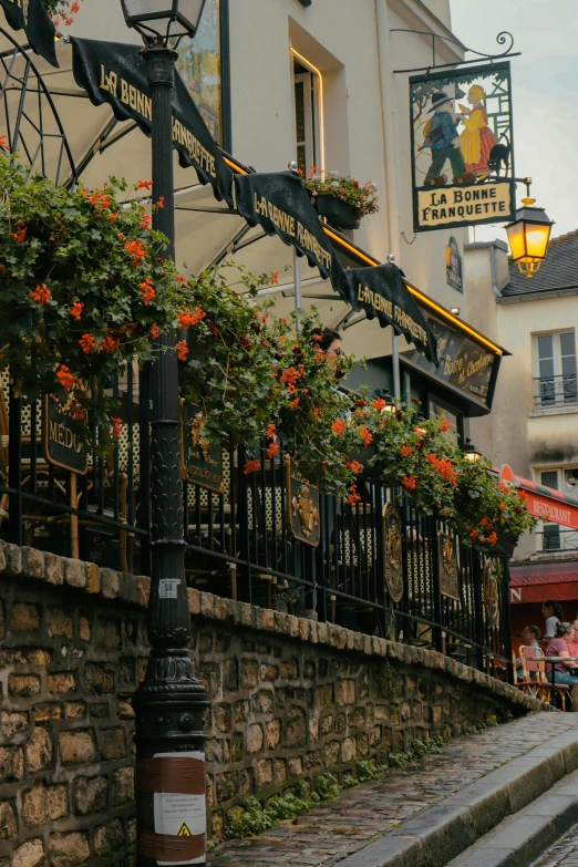 the street lights have flowered hanging from them