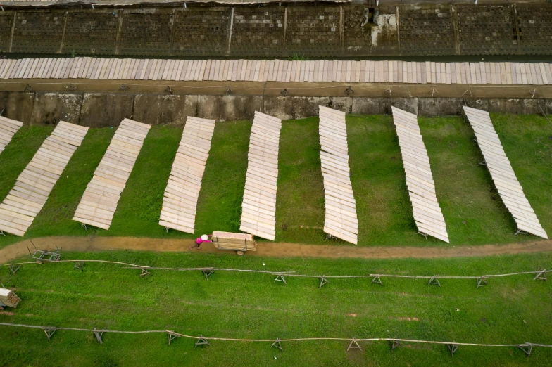 rows of white beds are laid out in an open field