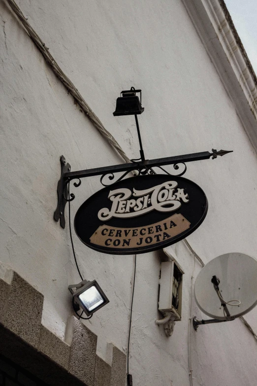 a street corner with a restaurant sign and clock