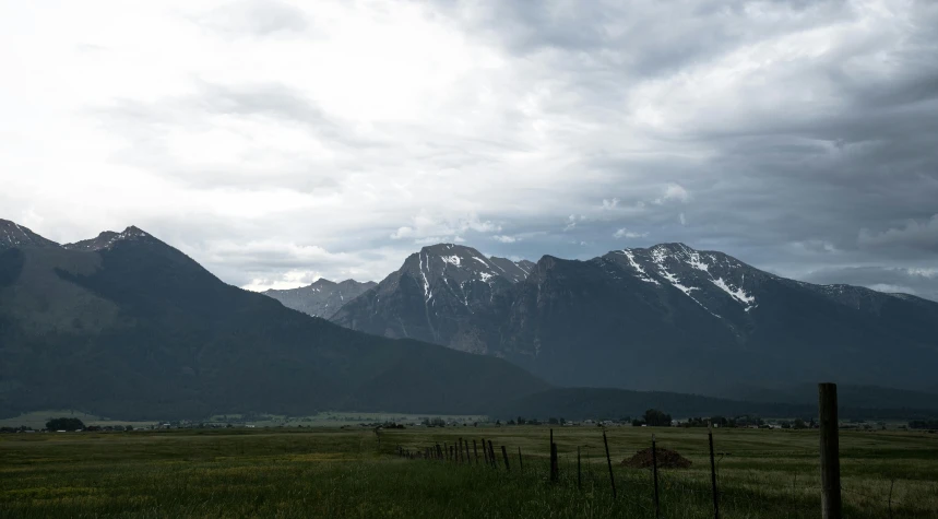 a field that has mountains in the background