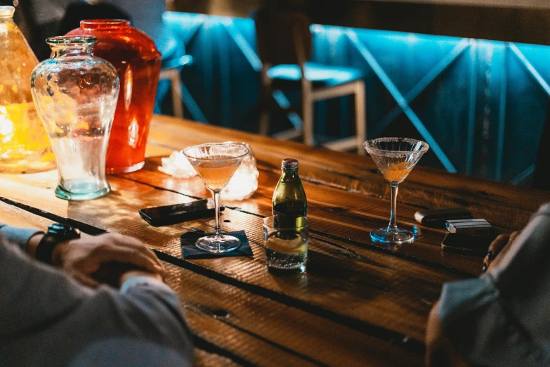 three empty wine glasses sitting on a wooden table