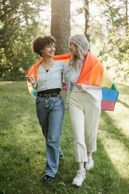 two woman with colorful scarves are walking together
