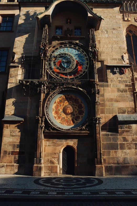 an old building with decorative clocks on the front