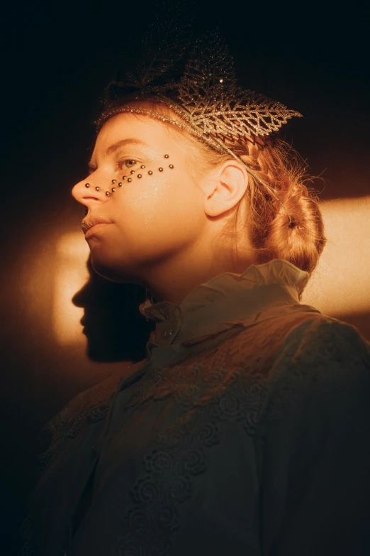 a woman with face glitter and head jewelry