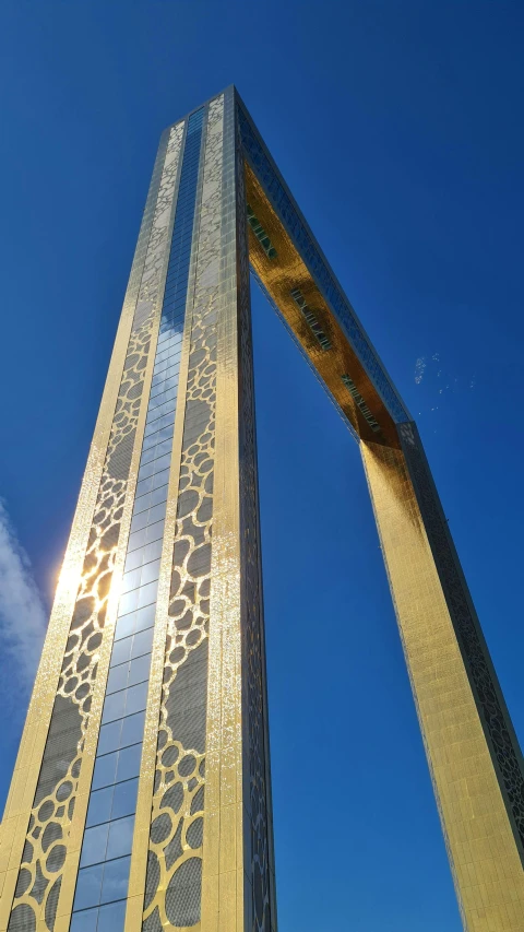 a large tall tower sitting next to a blue sky