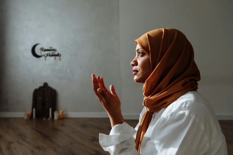 a woman standing in a living room, clapping