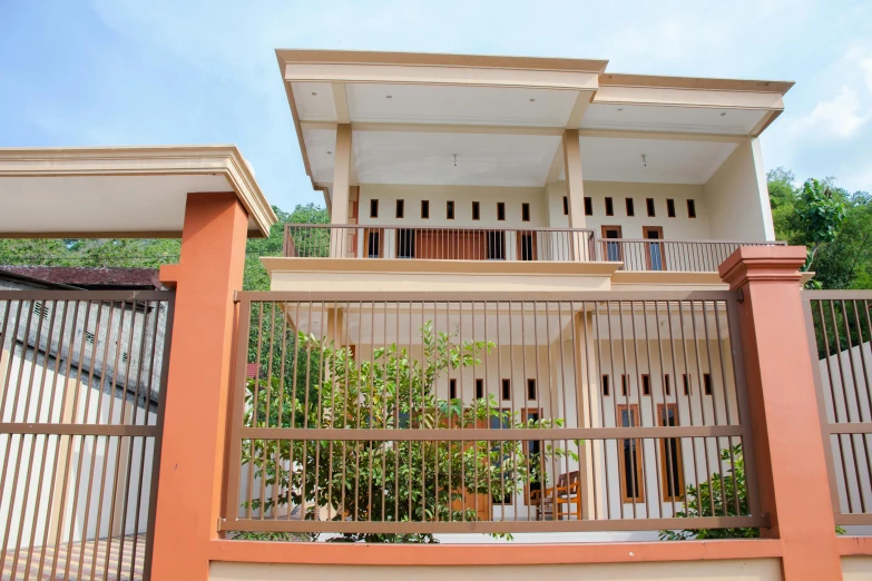 the balcony of this house is open and is covered with fencing