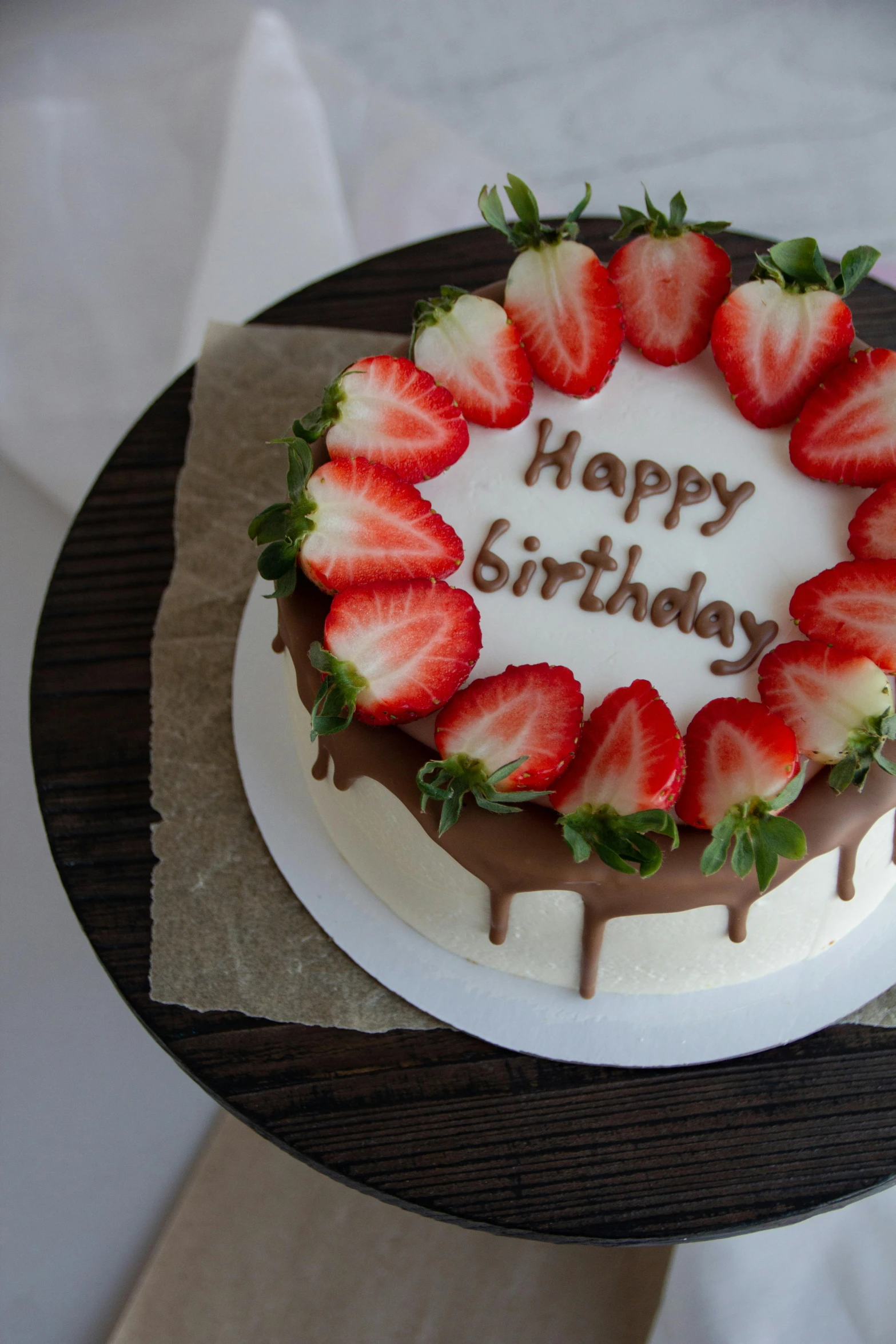 a cake is decorated with strawberries and chocolate on a plate