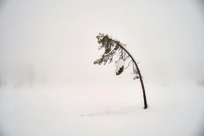 an object standing on the snow outside in the middle of the day