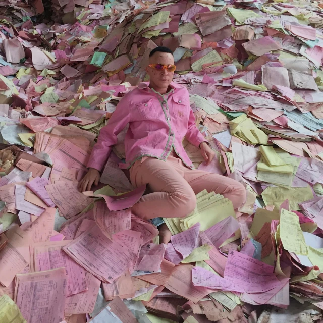 a person laying down on pink paper