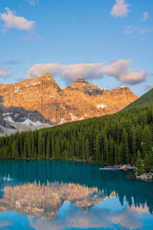 a boat in blue water next to some mountains