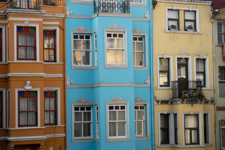 the many windows of different houses next to each other