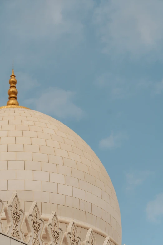 a white and gold domed building under a blue sky