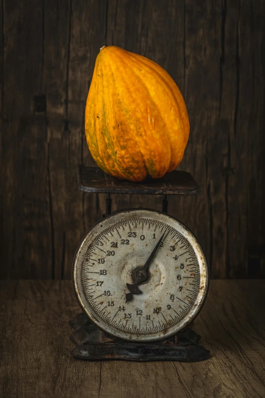 an orange pumpkin is sitting on top of a weighing scale