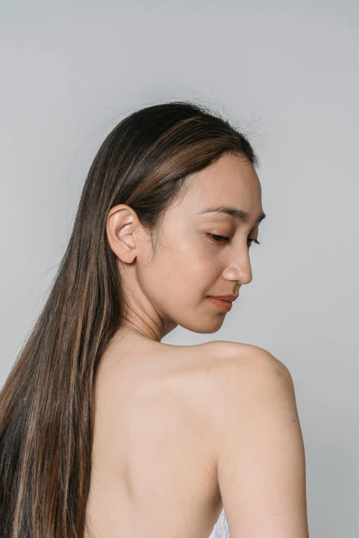 the back of a woman's shoulder as she poses for the camera