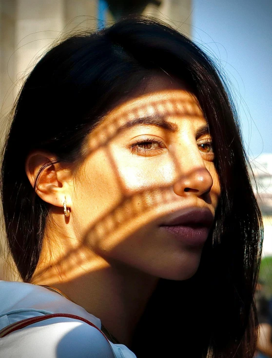 a young woman looking through the window, in the sunlight