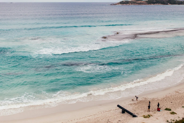 several people in the ocean with surfboards