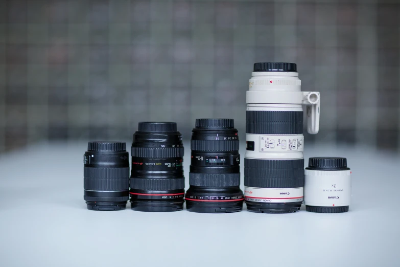 a bunch of cameras sitting around each other with lens cups on top