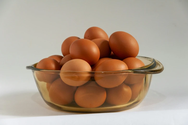 a bowl filled with eggs on top of a table