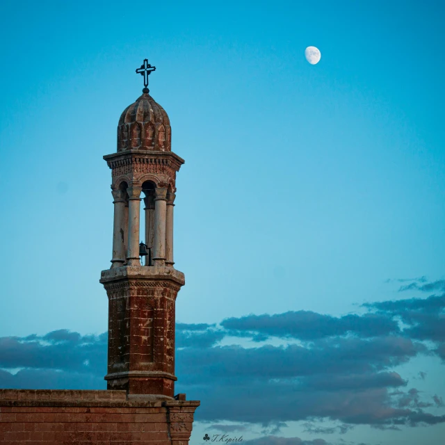 the building has a clock tower with an ornate spire on top