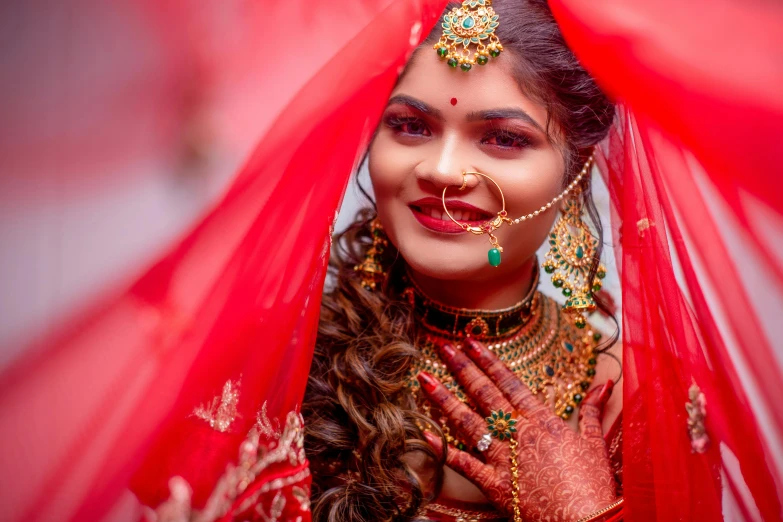 a bride smiles while looking over her veil