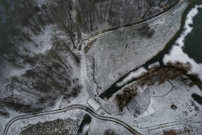 the ground with trees and snow covered hills