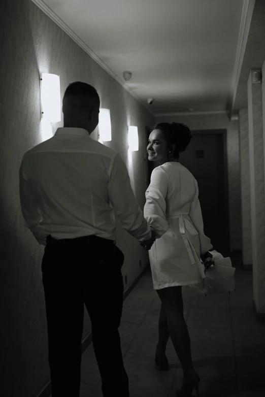 a man and woman are in a hallway together