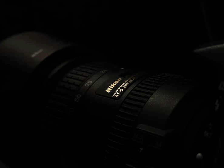 a large camera lens sitting in the dark