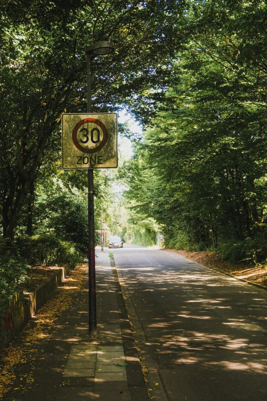 a sign is posted on the side of a road