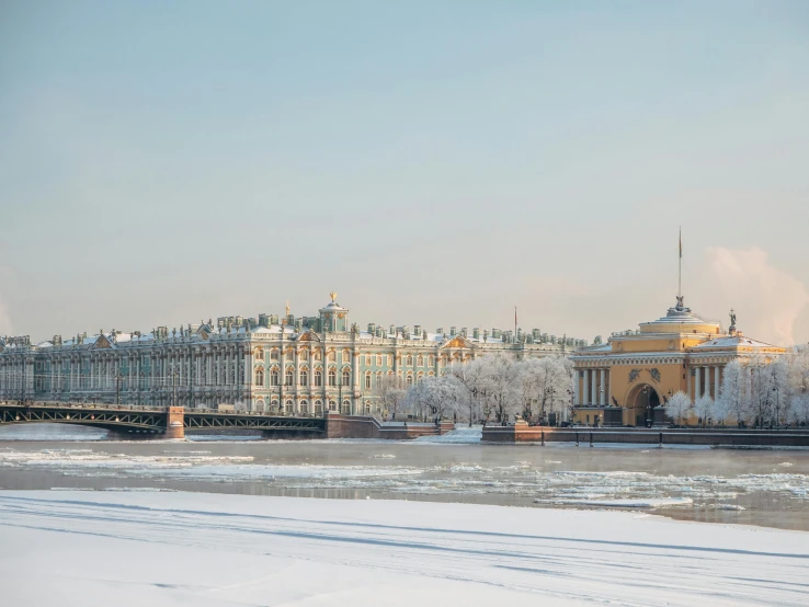 snow covers a field next to the palace