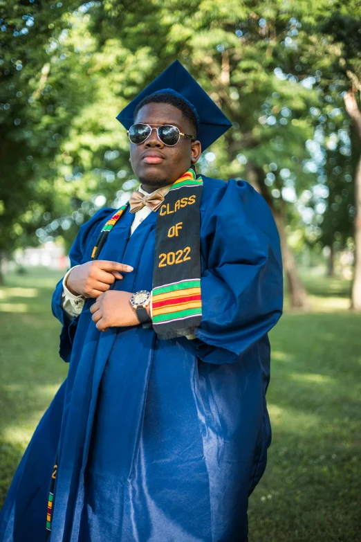 a man is dressed in his graduation gown