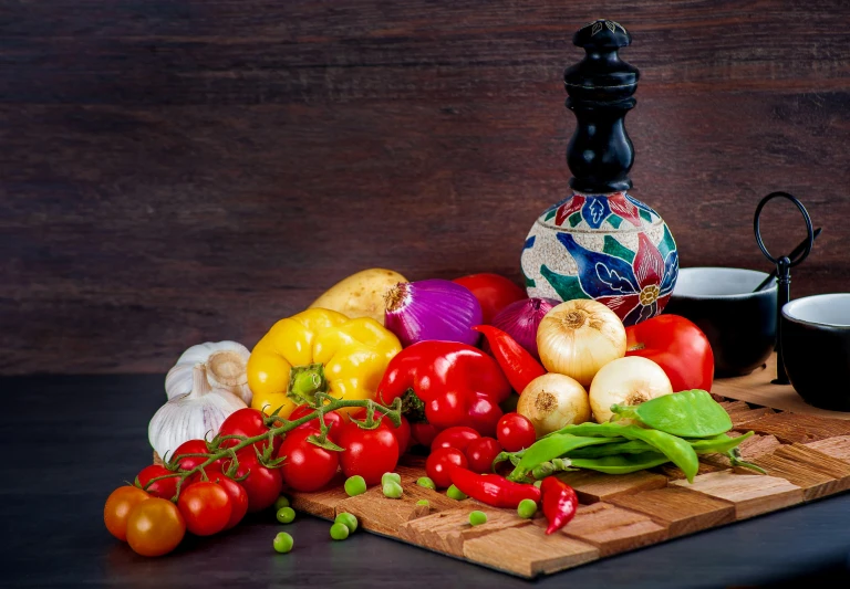 tomatoes, onions, bell peppers and peppers on a  board