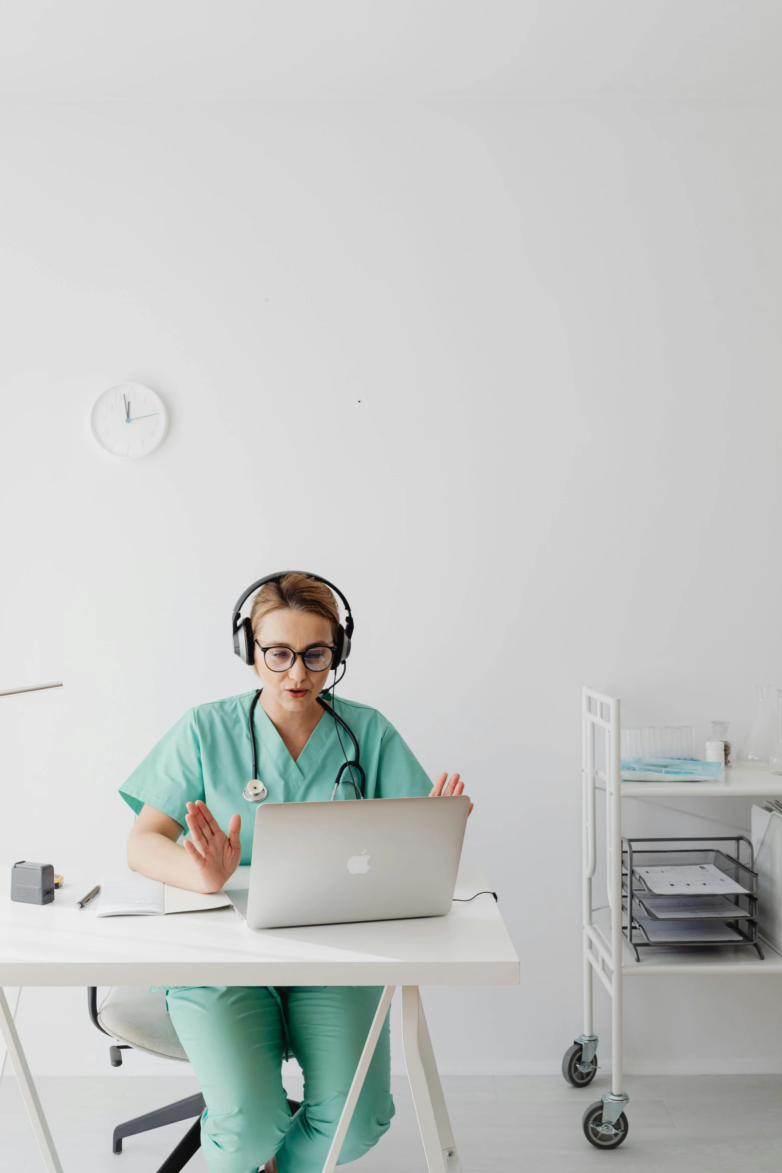 the person is working on a laptop computer at his desk