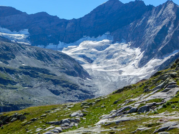 a view of a mountain range that is covered in snow