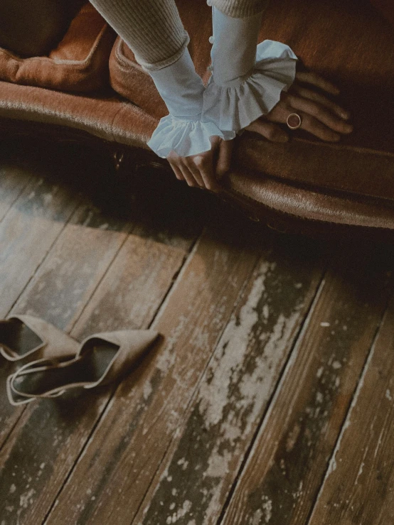 two pairs of shoes with one foot on the floor