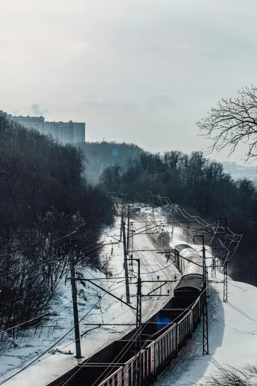 an empty train on the track near some snow