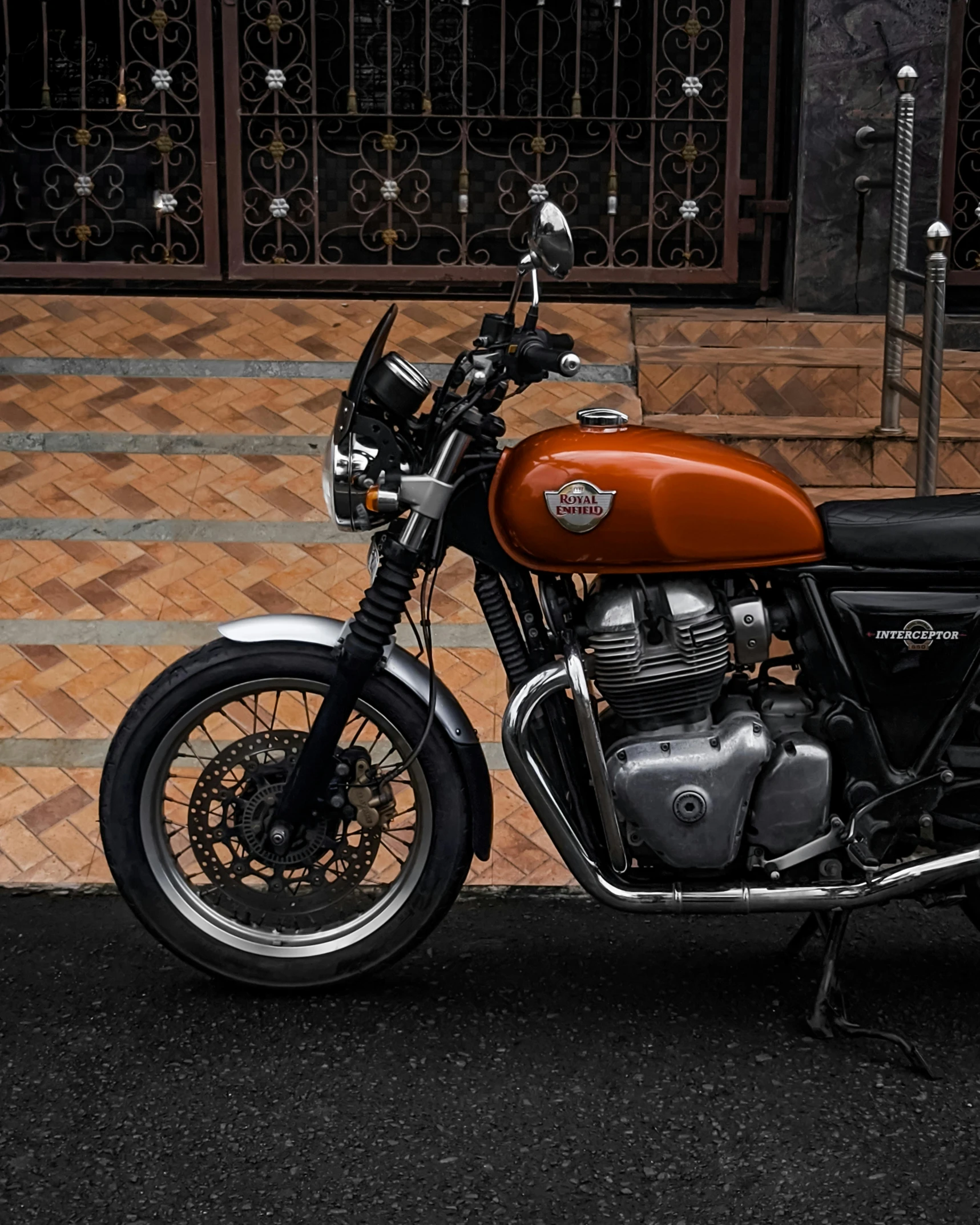 a motorcycle parked on the sidewalk in front of a building