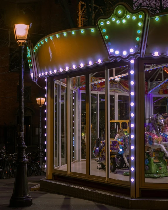 a carousel with lights and a person riding a bike