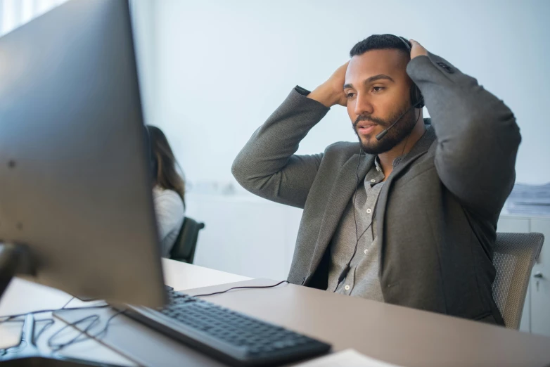 the man is sitting in front of his computer