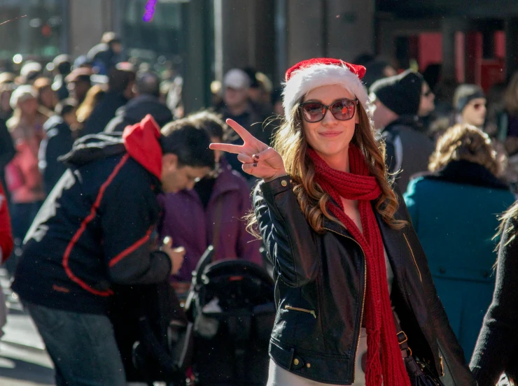 woman wearing glasses and a hat on the street