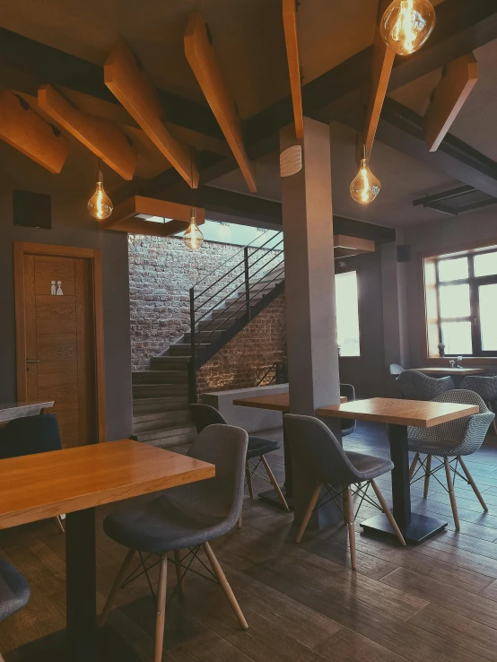 the interior of an empty restaurant with wooden tables