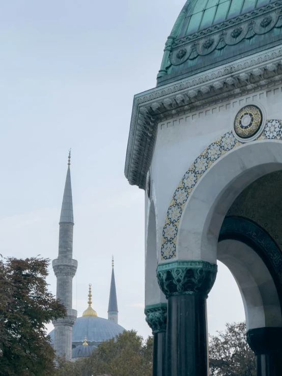 an arch leads to an area with the minalis in the background