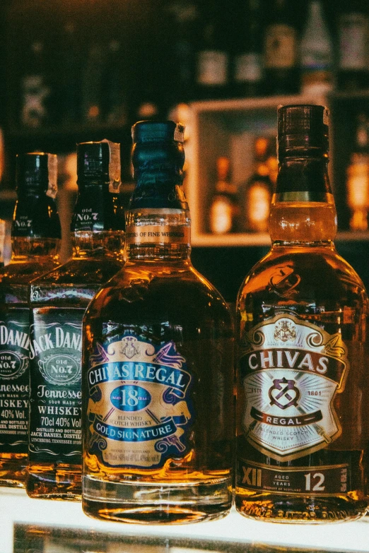 a row of bottles are lined up on a bar