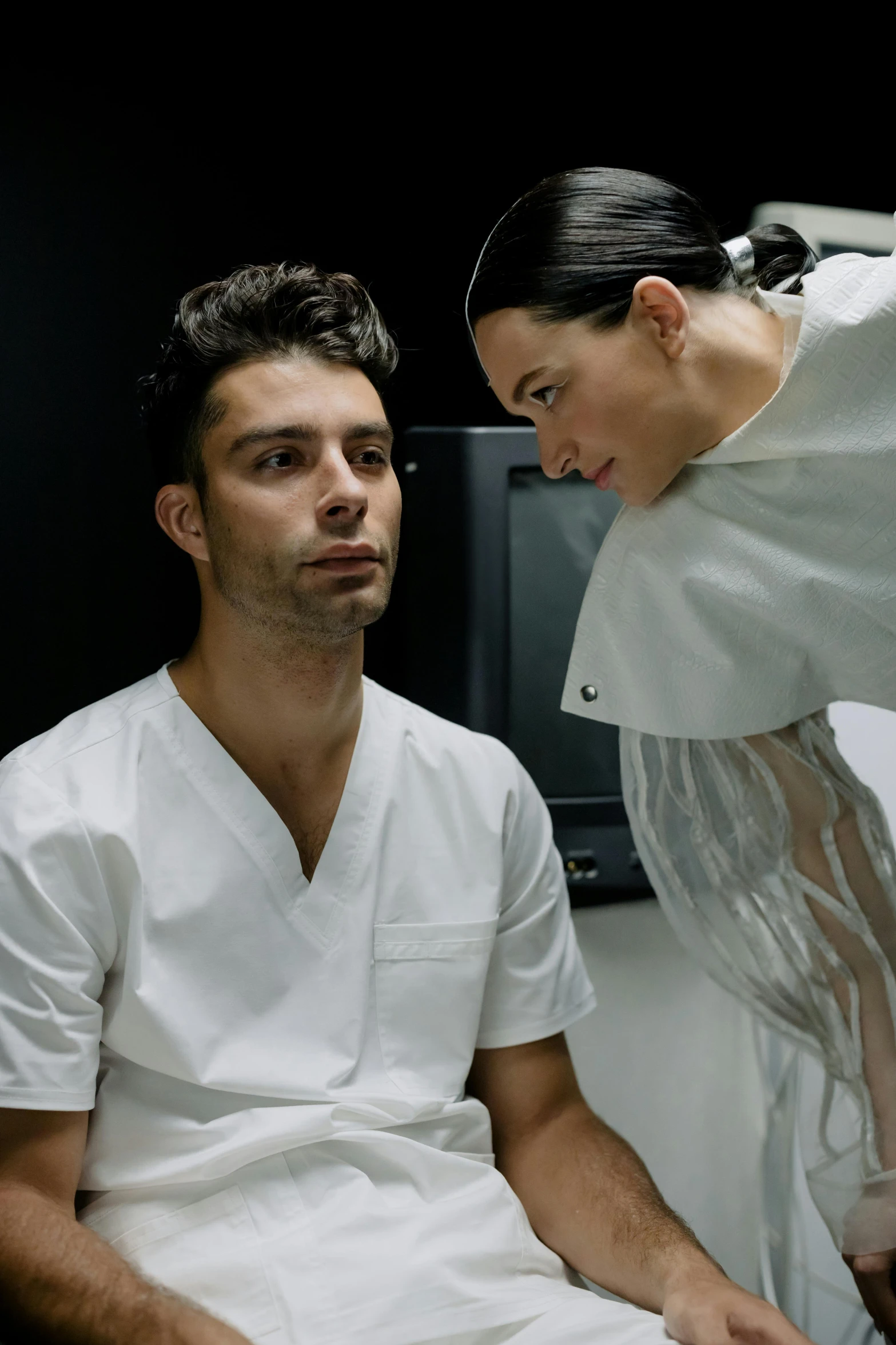 a woman helping a man with his medical work