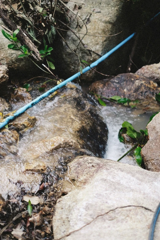 an orange and blue plastic object on top of a rock