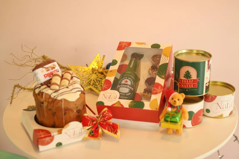 gifts on a table including some cookies and a teddy bear