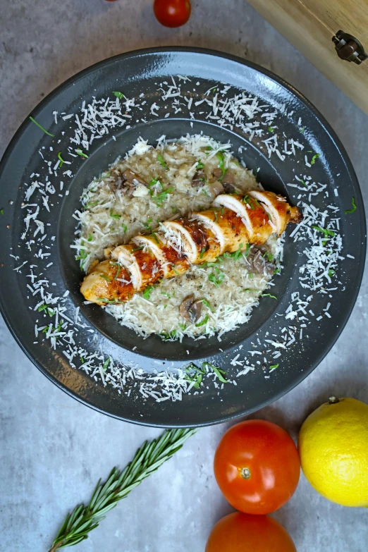 some food on a plate with tomatoes next to it