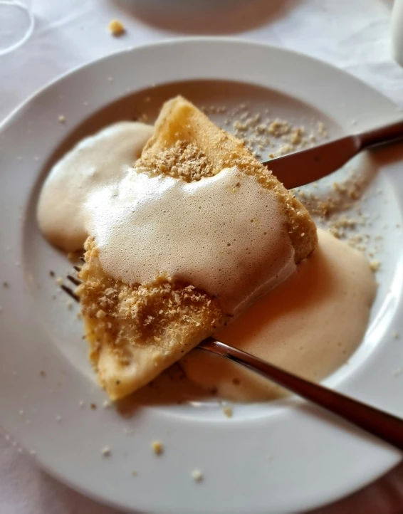 a plate with three spoons on it and one of the forks is holding an item that is powdered