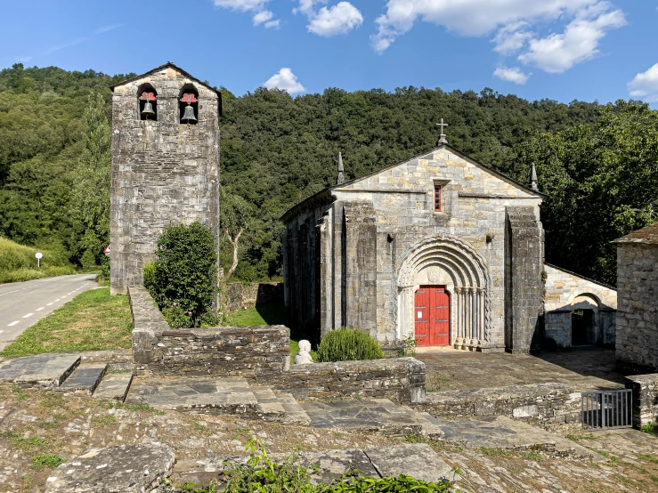 an old church with the front doors open